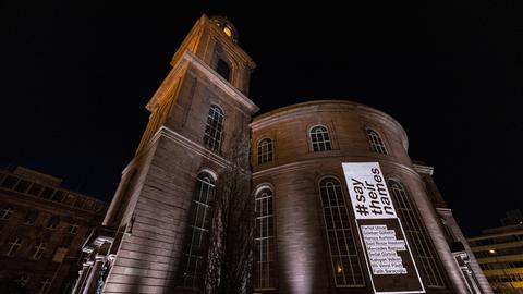 Die illuminierte Frankfurter Paulskirche bei Nacht. Die Namen der Opfer sowie der Hashtag "saytheirnames" sind auf der Fassade zu lesen. 