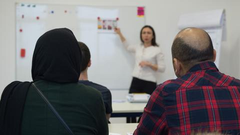 Asylbewerber in einem Erstorientierungskurs, der Einblicke in die deutsche Sprache und Kultur vermittelt. 