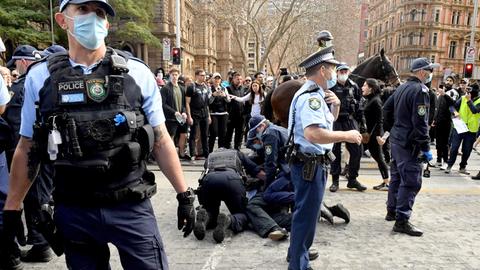 Ein Demonstrant wird von der Polizei bei Anti-Lockdown-Protesten in Australien festgenommen. 