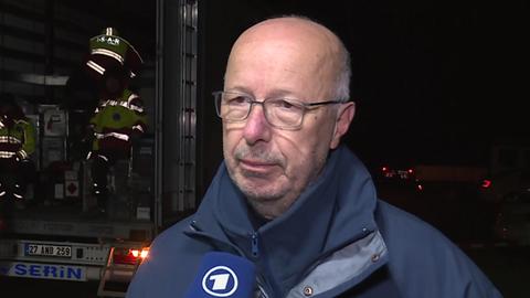 Peter Benz, Gruppenführer THW Hofheim - Mann mittleren Alters mit Brille, blauer Jacke, hr/ARD-Mikrofon
