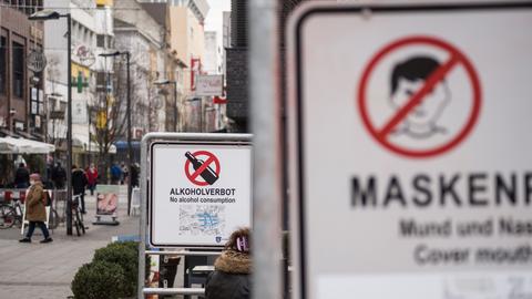 Schilder machen in der Offenbacher Fußgängerzone auf das Alkoholverbot und die Maskenpflicht aufmerksam. 