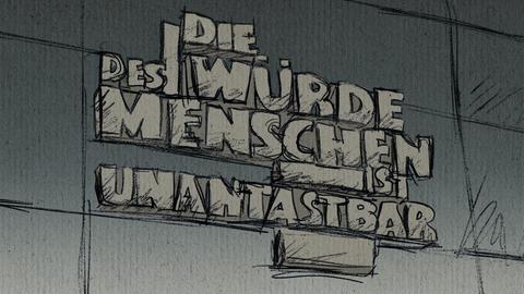 Zeichnung des Zitats "Die Würde des Menschen ist unantastbar" an der Außenwand des Gerichts.