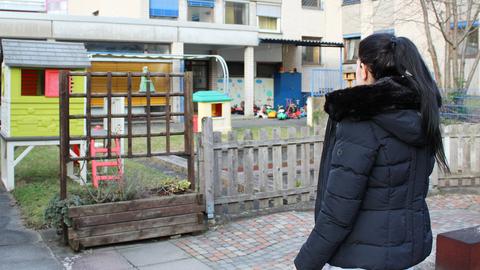 Eine der inhaftierten Mütter steht auf dem Spielplatz der Justitzvollzugsanstalt. Damit man ihr Gesicht nicht sehen kann, ließ sie sich von hinten fotografieren.