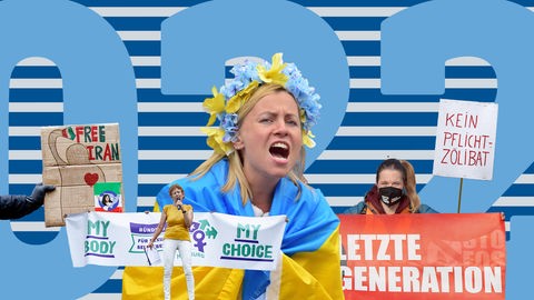 Vor einer Fläche mit der großen Zahl "2022" sind diverse Elemente angeordnet: Demostrationsschilder mit den Botschaften "Kein Pflicht-Zölibat", "Free Iran", My Body - My Choice", "Letzte Generation" und eine Frau in eine ukrainische Flagge gehüllt mit einem weiß-blau-gelb-farbenen Blumenkranz im Haar, die kräftig ruft.