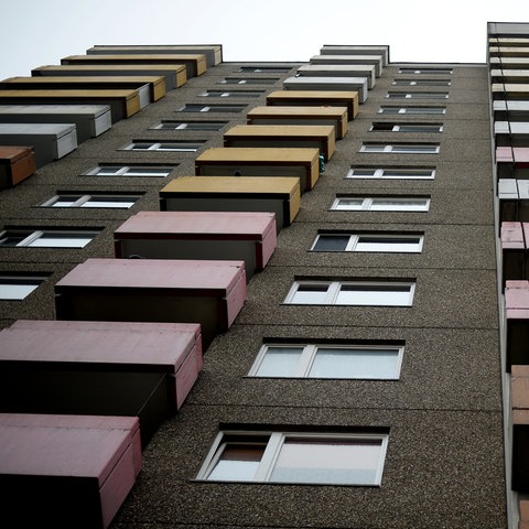 Ein Wohnhochhaus mit bunten Balkonen aus der Froschperspektive