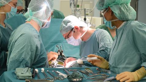 Ärzte transplantieren eine Niere.