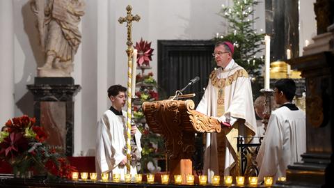 Christmette 2023 im Dom zu Fulda - Bischof Gerber am Lesepult - flankiert von zwei Ministranten