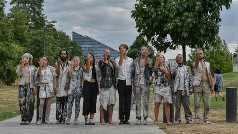 Das Ensemble von antagon theaterAktion - elf Menschen am Frankfurter Mainufer.