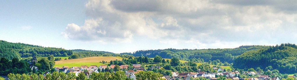 Ein Blick aus der Ferne auf die Gemeinde Lahntal, umgeben von malerischer Landschaft.