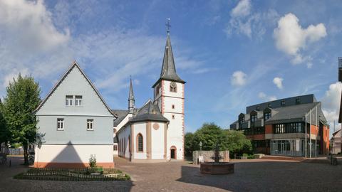 Eine kleine Kirche in Mörlenbach mit Umgebungsbebauung.