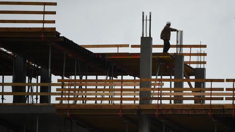 Bauarbeiter auf einer Baustelle im Gegenlicht