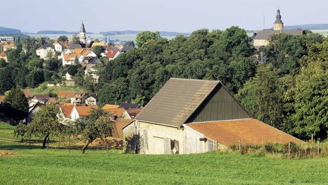 Ein Dorf aus der Ferne fotografiert - umrahmt von der umgebenden Landschaft.