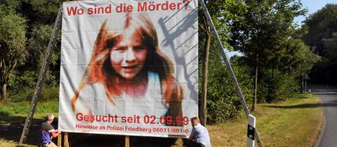 2009: Polizeibeamte bauen ein Plakat auf, mit dem zu Hinweisen im Mordfall der kleinen Johanna Bohnacker aufgerufen wird.