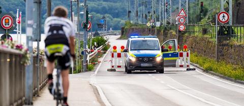 Polizeiwagen an Straßensperrung neben dem Rhein