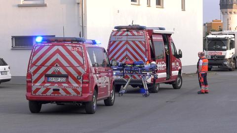 Feuerwehrleute stehen vor dem Gelände.