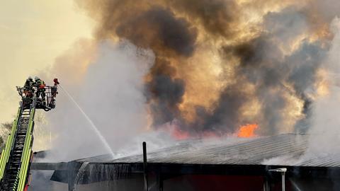 Die Feuerwehr bei den Löscharbeiten an der brennenden Halle