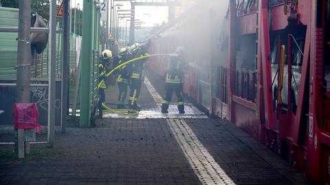 Einsatzkräfte löschen einen brennenden Autozug in Butzbach