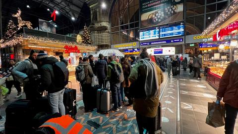 Lange Schlange von Menschen vor Schalter im Frankfurter Hauptbahnhof