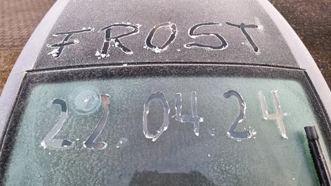 Auf einem Auto ist mit Fingern in den Frost geschrieben: Frost 22.04.2024
