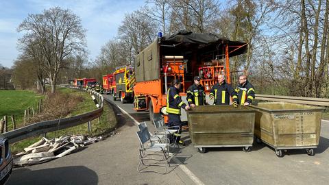 Einsatzfahrzeuge stehen auf einer Landstraße.