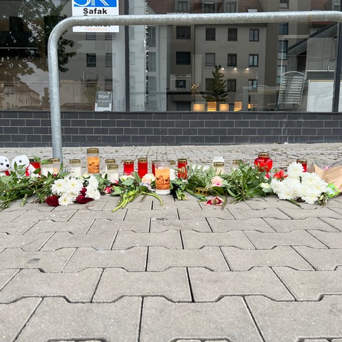Blumen und Kuscheltiere vor Haus