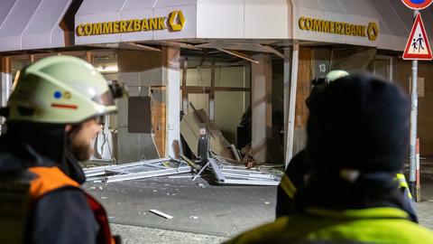 Beschädigte Commerzbank-Filiale, Feuerwehrleute im Vordergrund