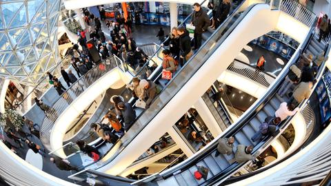 Viele Menschen auf Rolltreppe in weihnachlichem Kaufhaus