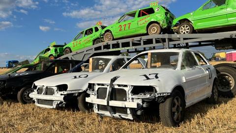 Mehrere Autos (in grün und weis) stehen für das Rennen bereit.