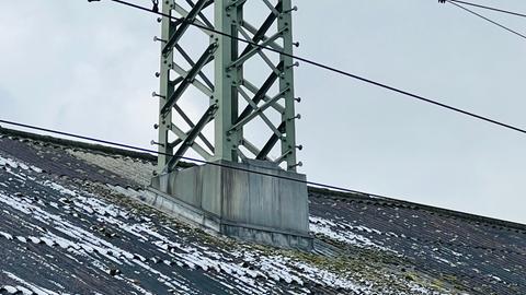 Strommast ragt aus Gebäudedach in Fulda 