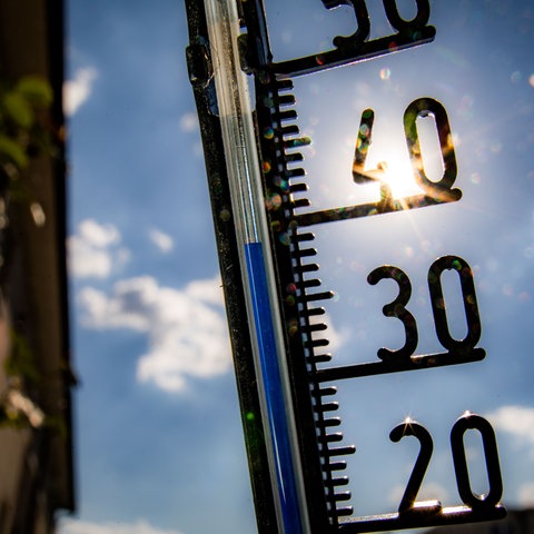 Ein Thermometer an einer Hauswand zeigt Temparaturen in Richtung der 40-Grad-Marke an.