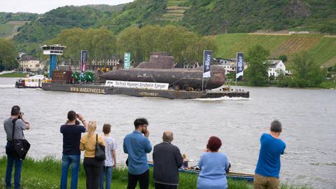 Schaulustige beobachten u-Boot-Transport auf dem Rhein