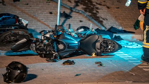 Ein zerstörtes Motorrad liegt nach einem Unfall auf einem Parkplatz.