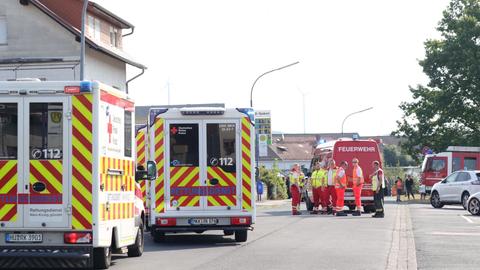 Rettungswagen und Feuerwehr auf einer Straße vor einem Gebäude