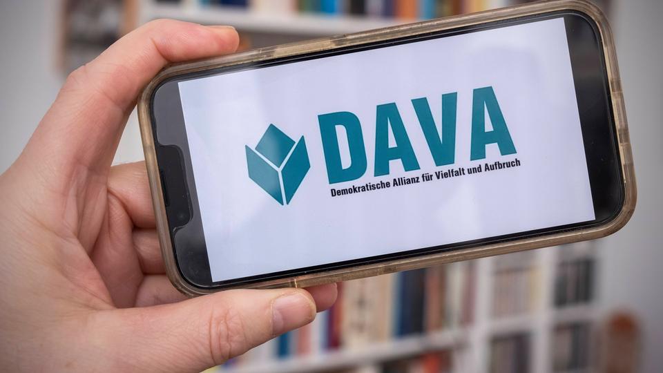 Handy mit DAVA-Logo, von Hand gehalten