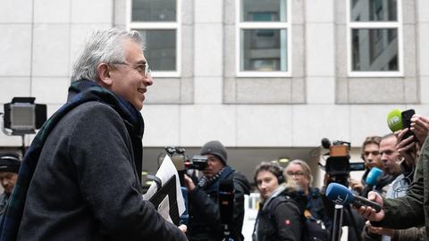 Peter Feldmann geht an Medienleuten vor dem Gerichtsausgang vorbei.