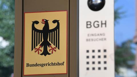 Schild mit der Aufschrift "Bundesgerichtshof" und einem Bundesadler an einer Wand.