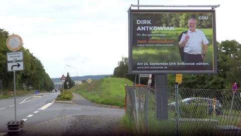 Ein großflächiges Wahlplakat hängt am Straßenrand in Neustadt (Marburg-Biedenkopf)