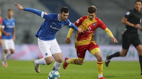 Luca Pfeiffer von Darmstadt 98 im Duell mit Marvin Wanitzek vom KSC