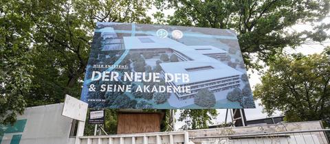 Ein Schild auf einer Mauer mit der Aufschrift "Der neue DFB & seine Akademie".