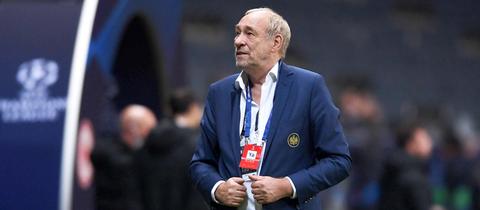Peter Fischer steht in einem Stadion und schaut nach oben.