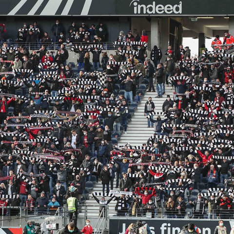 Eintracht Frankfurt fans raise their scarves