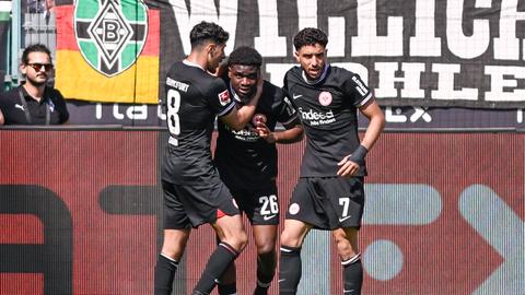 Eric Dina-Ebimbe ( 26, Eintracht Frankfurt) jubelt nach dem Tor zum 1:1 mit Fares Chaibi und Omar Marmoush.