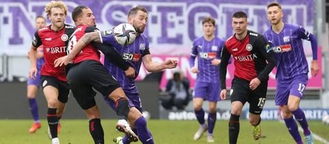 Spieler des SV Wehen Wiesbaden und des VfL Osnabrück kämpfen um den Ball