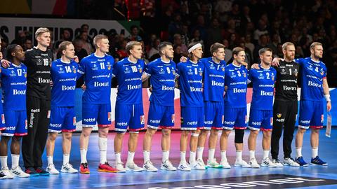 Die isländische Handball-Nationalmannschaft steht Arm in Arm in einer Reihe