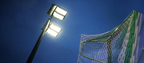 Ein Flutlicht strahlt auf den Fußballplatz