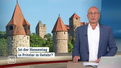 Moderator vor Bild mit Topthema