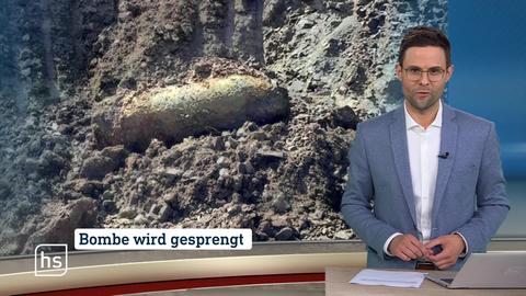 Moderator vor Bild von Topthema