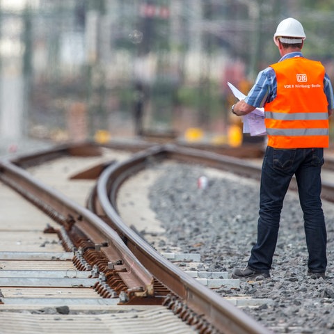 Ein Bahn-Mitarbeiter auf gesperrten Gleisen.