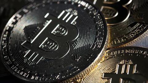 ILLUSTRATION - Bitcoin-Münzen liegen auf einem Tisch