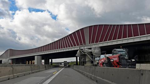 Baufahrzeug an Brücke über Autobahn